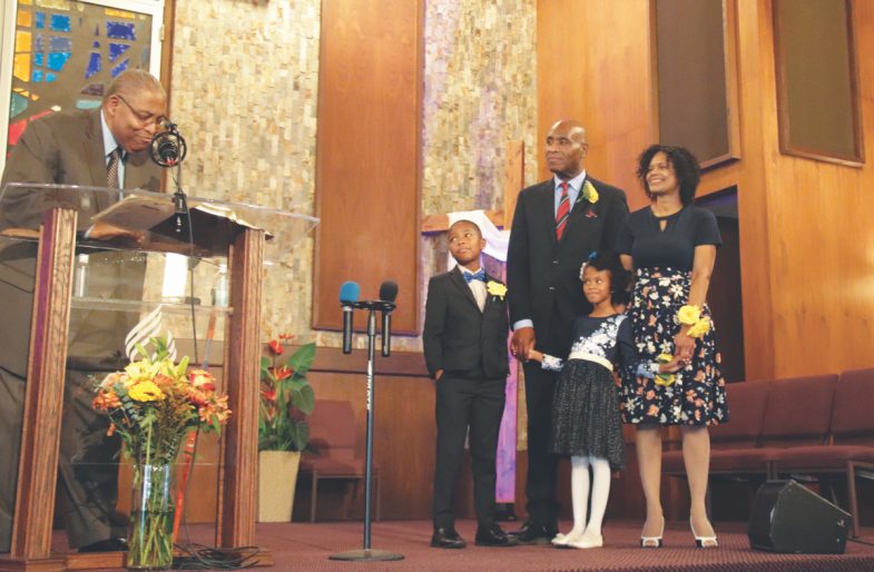At Peter Baptiste’s ordination, Lee encourages him to “preach the word” in his ministerial charge. (Photo: Araya Moss)
