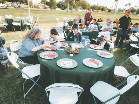 Community members pray before their meal.