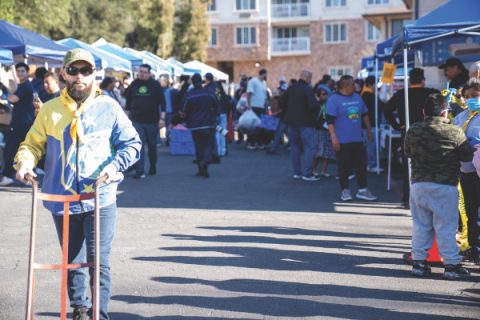 The distribution at SCC was originally planned for indoors but quickly moved outdoors due to the incredible amount of donations received. Volunteers collaborated to place items in trunks of cars as people drove through (Photo: Araya Moss)