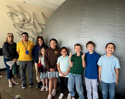 Students and staff from Adobe Adventist Christian School stand outside of the inflated dome that houses the STARLAB.