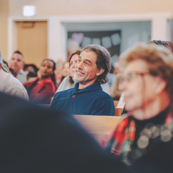 A moment of joy as a church member listens, reflecting the excitement and anticipation for this new chapter at Wasatch Hills.