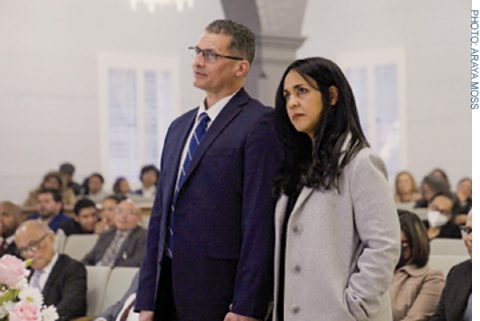 Rivera and his wife stand to receive the call to ministry as Royal Harrison, SCC Executive Secretary, addresses them.