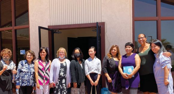 While visiting Rolling Hills church this summer, Mira (third from right) stands with her prayer warriors, holding the Bible they gave her.