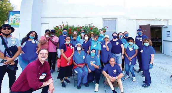 Volunteers gather for a photo before opening the doors to welcome shoppers for the most recent event on August 15, 2021.