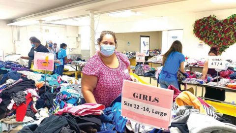 One shopper chooses free clothing items for her family.