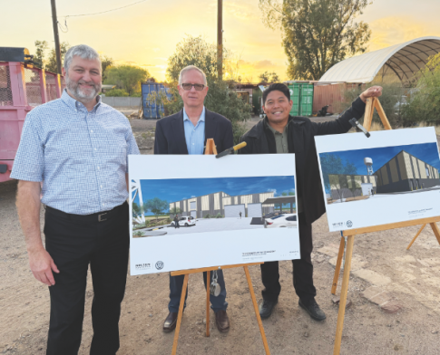 From left to right: Board Chairman Ed Keyes, Financial Chairman Reggie Leach, and Principal Michael Tomas stand by the artist's renderings of the new maintenance facility.