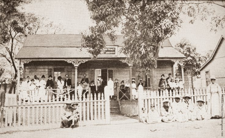 The Tract and Missionary Society in Honolulu, Hawaii, in 1885; Pastor La Rue is pictured standing in a doorway in the back.