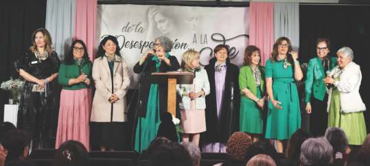 The Hispanic women’s ministry committee stand in recognition.