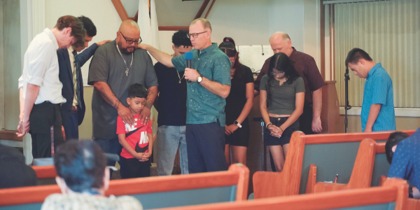 Members of the Orosi Church praying over the José family.