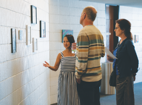 Mae Chinn shares information about the artwork with some visitors. (Photo: Lauren Lacson)