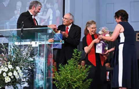 Ed Keyes (left) and Lilian Keyes (right) give gifts of appreciation to Dale and Nancy Wolcott at Camp Meeting.