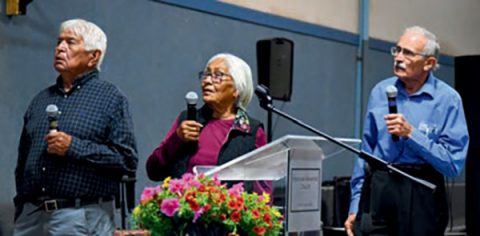 Dale Wolcott (right) singing hymns in the Navajo language along with Navajo church members at the Navajo Camp Meeting in May.