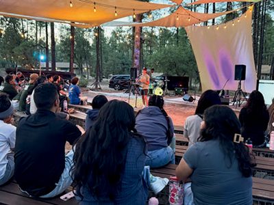 An audience of young adults listens to Eliab Quinones, who was the featured speaker for the Young Adult Ministries program at Arizona
Camp Meeting 2025.