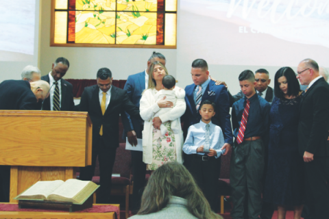 Prayer of ordination over Ortega and his family.