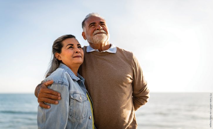 Senior couple looking away admiring the view on the beach