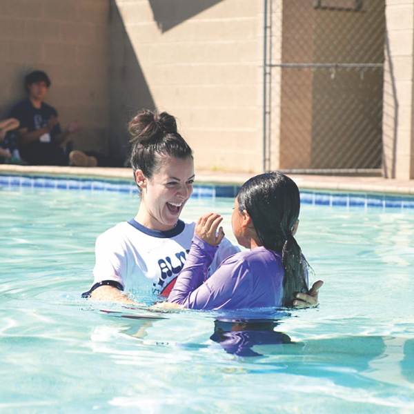 Pastor Sarah Oliviera baptizes a camper during Junior 1 week of summer camp.