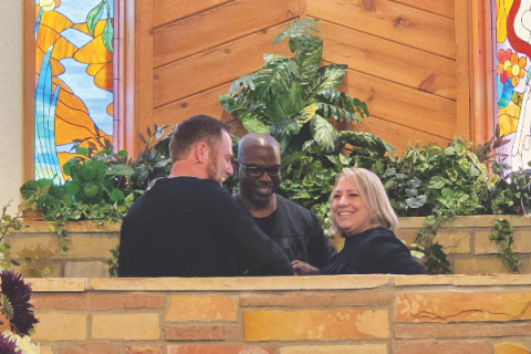 Pastors Eaton (left) and Lemon celebrate with a baptismal candidate on Sabbath, August 30.