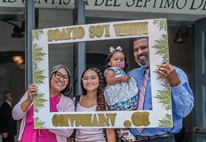 Members pose with a sign to commemorate the special day.