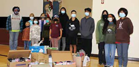 The student council at Miramonte Adventist Elementary School display the 800 pairs of socks that the school collected during “Socktober.”