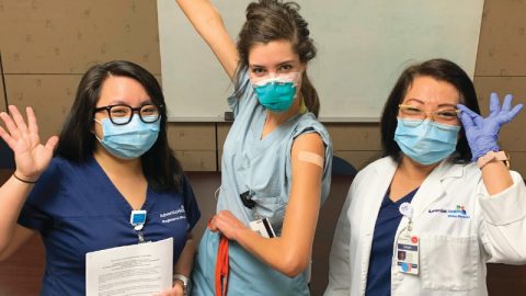 Karen Ong, left, and her mother, Esther Ong, right, after administering a COVID-19 vaccine.