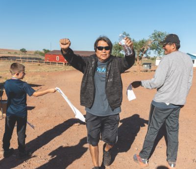 Larry Haycock celebrates crossing the finish line at the Sunday morning fun run. 