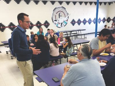 Jonathan Chitwood talks with attendees at Sabbath morning breakfast.