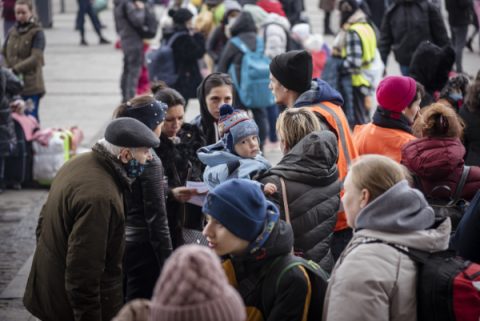 Lviv, Ukraine - March 3, 2022: A crowd of people transiting through Lviv stand outside the Lviv train station.