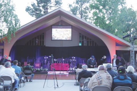 Attendees gather outside with blankets and warm beverages ahead of the outdoor performance.