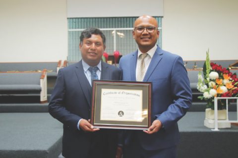 First Elder Juventino Vargas (left) and Pastor Ellis Flores (right) are pictured holding the certificate of organization. 