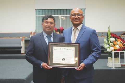 First Elder Juventino Vargas (left) and Pastor Ellis Flores (right) are pictured holding the certificate of organization.