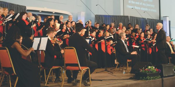 Dennis Marsollier leads the Camp Meeting Anthem Choir and Orchestra during the worship service on Sabbath, June 18.