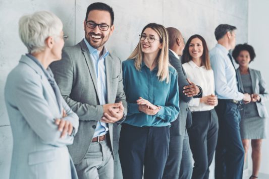 Multi-ethnic group of people in formal businesswear standing in a row
