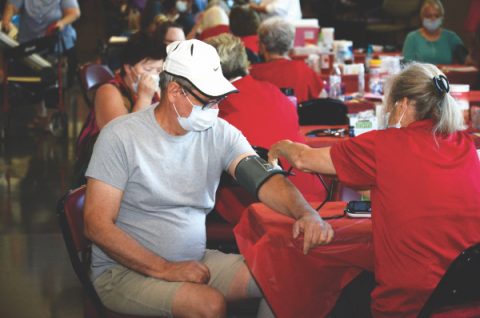 Medical volunteers check vitals before guests enter the facility.