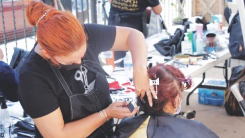 Students and teachers from Professional Institute of Beauty School gave free haircuts.