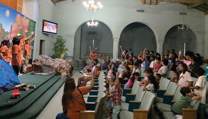 Children sing along to the interactive music. Of the approximately 60 kids who attended VBS each night, 15 were new to the church from the neighborhood.