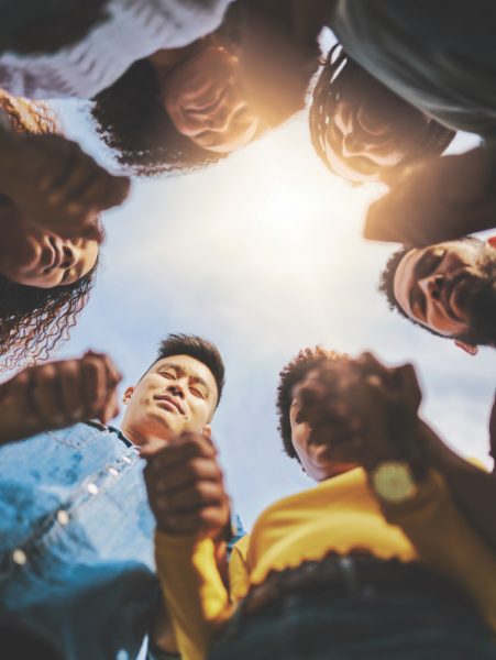 Cropped shot of a group of friends holding hands