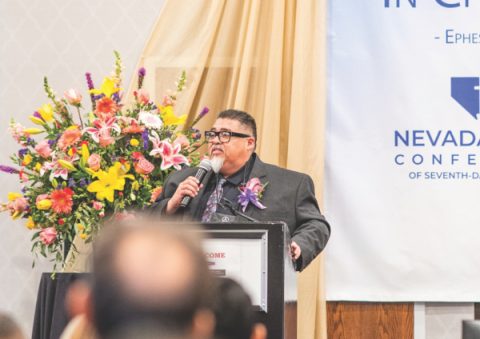 Elder Carlos Camacho addresses the delegates with a presidential challenge to be unified in spirit and service.
