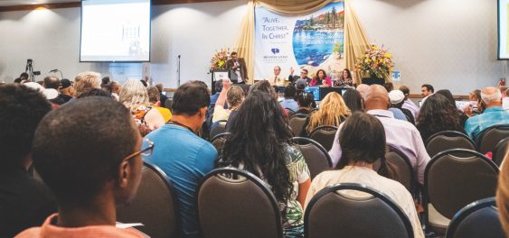 Elder Rudy Alvir, NUC children, youth, and young adult director, instructs delegates on use of electronic devices.