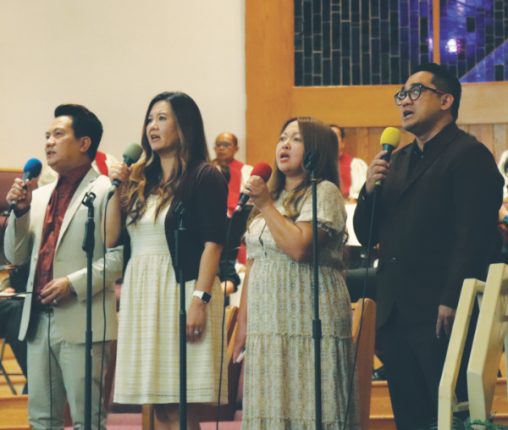 The praise team leads the congregation in singing “Wings of an Eagle,” the 65th anniversary theme song, which was performed various times throughout the day.