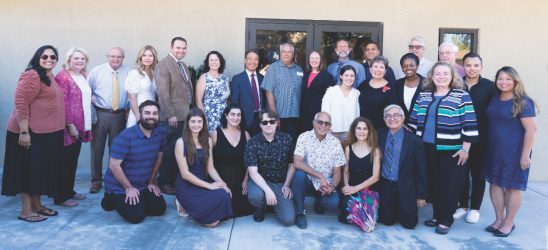 Pastors, church and community leaders, and the Elias family gather to celebrate.