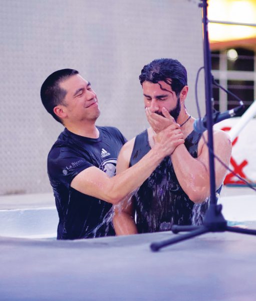 La Sierra University Chaplain Jason Decena baptizes student Christian Figueroa.