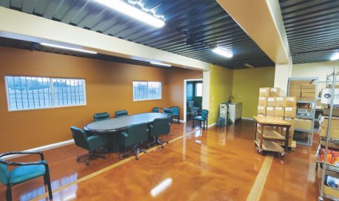 Seen from the left, the interior of the Literature Ministry Distribution and Training Center shows the conference room and storage areas.