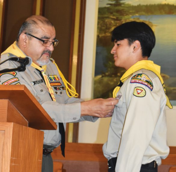 Martinez presents Erik Fernandez with his baptismal pin.