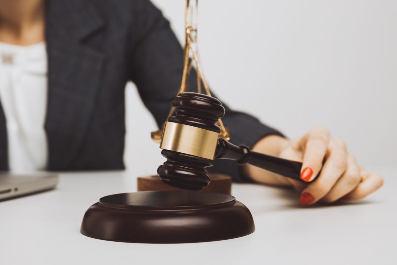 Woman notary with wooden gavel isolated