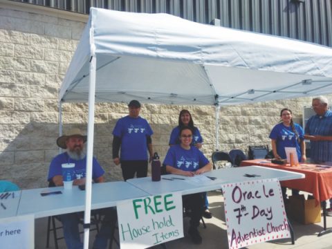 Members of the Oracle Church prepare to pass out household items to families in need.