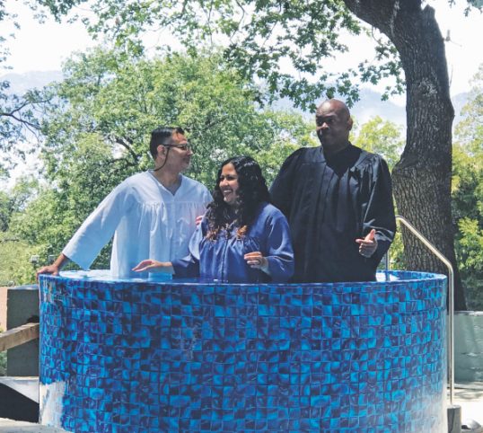 One attendee is baptized at the Memorial Day weekend retreat at Camp Cedar Falls. (Left to right) David Solis, Pasadena Bible instructor; Cynthia Calderon, baptismal candidate; and Pastor Michael Johnson. 