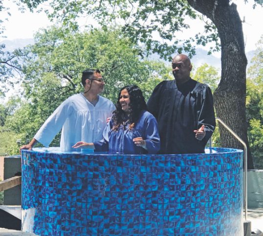 One attendee is baptized at the Memorial Day weekend retreat at Camp Cedar Falls. (Left to right) David Solis, Pasadena Bible instructor; Cynthia Calderon, baptismal candidate; and Pastor Michael Johnson.