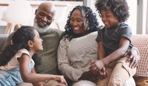 Shot of two adorable young siblings bonding and spending time with their grandparents at home