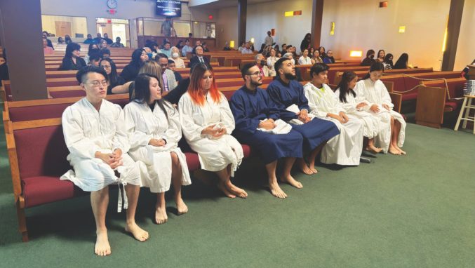 Candidates are seated before baptisms begin. Additional robes were borrowed from Living Stones church.