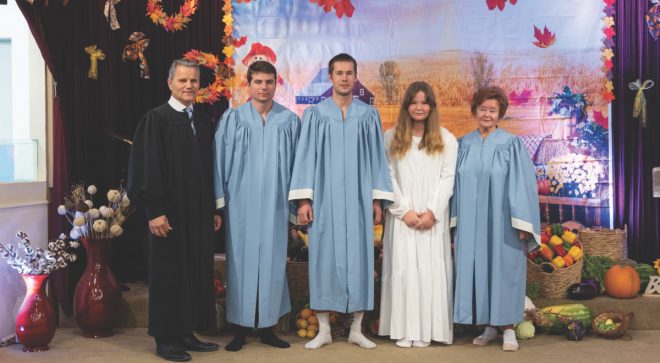 (From left to right) Gurduiala, Oleg, Ruslan, Violina, and Ludmila pose for a photo before the baptisms.